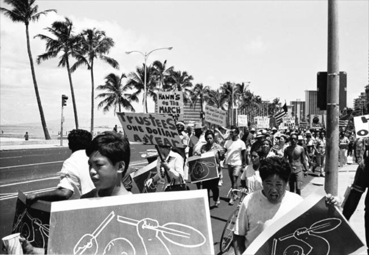 Photo of protest march with posters of 'Broken Paddle'.  Ian Lind.